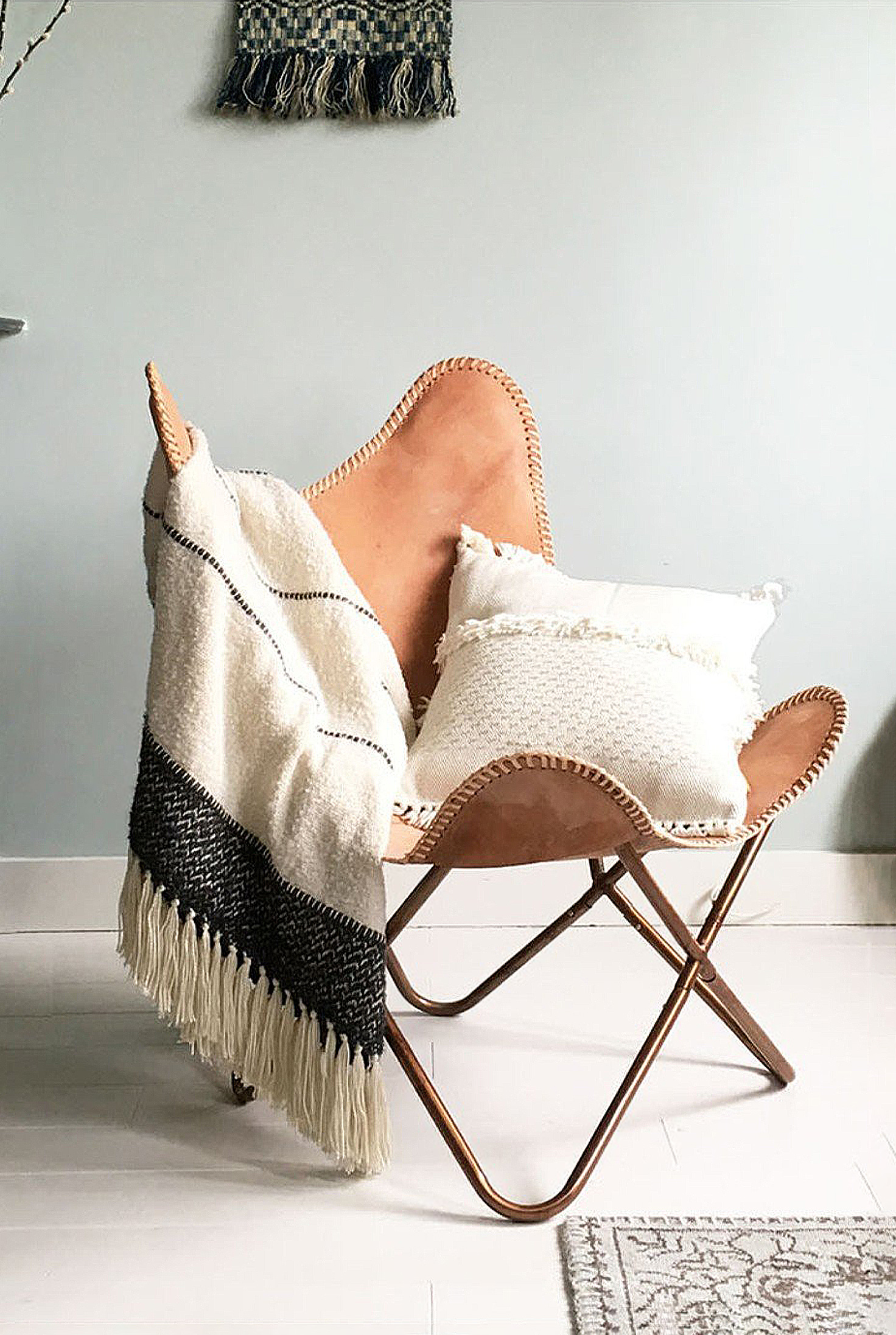 Stoel gedrapeerd met warm plaid van HAY